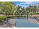 Community playground with swings and bench seating surrounded by lush landscaping at 2826 Barrow Downs St, Las Vegas, NV 89135