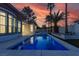 Backyard featuring a sparkling pool with accent lighting and a lushly landscaped surrounding area at 2826 Barrow Downs St, Las Vegas, NV 89135