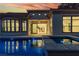 Backyard pool at dusk with cascading water feature and views of the home's architectural details at 2826 Barrow Downs St, Las Vegas, NV 89135