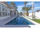 Backyard with a modern pool, turf, patio, and desert landscaping at 2826 Barrow Downs St, Las Vegas, NV 89135