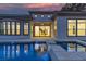 Backyard pool at dusk with cascading water feature and views of the home's architectural details at 2826 Barrow Downs St, Las Vegas, NV 89135