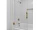 Modern shower featuring white herringbone tile, glass door, and gold hardware at 2826 Barrow Downs St, Las Vegas, NV 89135