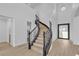 Grand foyer with decorative staircase and modern glass front door at 2826 Barrow Downs St, Las Vegas, NV 89135