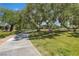 A scenic walking path surrounded by mature trees and lush landscaping at 2826 Barrow Downs St, Las Vegas, NV 89135