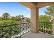 Balcony view with wrought iron railing overlooking a neighborhood with trees and palm trees under a blue sky at 3010 Hammerwood Dr, Las Vegas, NV 89135