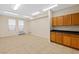 Open basement featuring tile floors, storage cabinets, and natural light from windows at 3010 Hammerwood Dr, Las Vegas, NV 89135