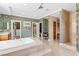 Luxurious bathroom features a sunken tub, marble accents, patterned wallpaper, and a glass-enclosed shower at 3010 Hammerwood Dr, Las Vegas, NV 89135