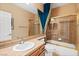 Bathroom features single sink vanity, large mirror and shower-tub combo with glass doors at 3010 Hammerwood Dr, Las Vegas, NV 89135