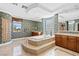A stunning bathroom featuring dual vanities, tub, and tile flooring at 3010 Hammerwood Dr, Las Vegas, NV 89135