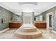 A gorgeous bathroom featuring dual vanities, tub, and tile flooring at 3010 Hammerwood Dr, Las Vegas, NV 89135