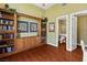 Charming room with hardwood floors, built-in shelves and cabinets, and access to an attached bathroom at 3010 Hammerwood Dr, Las Vegas, NV 89135