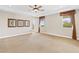 Spacious bedroom featuring a ceiling fan, neutral walls and large windows at 3010 Hammerwood Dr, Las Vegas, NV 89135