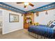 Comfortable bedroom with a ceiling fan, built-in shelving, and a blue plaid bed at 3010 Hammerwood Dr, Las Vegas, NV 89135