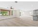 Open bonus room with travertine floors connects seamlessly to the kitchen, providing ample space for entertaining at 3010 Hammerwood Dr, Las Vegas, NV 89135