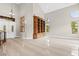 Elegant foyer with soaring ceilings, marble floors, and custom shelving flanking the front door at 3010 Hammerwood Dr, Las Vegas, NV 89135