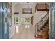 Grand foyer boasts soaring ceilings, tile flooring and a curved staircase at 3010 Hammerwood Dr, Las Vegas, NV 89135