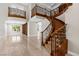 Elegant foyer featuring a curved staircase, grand balcony and travertine floors at 3010 Hammerwood Dr, Las Vegas, NV 89135