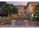 Charming home showcasing a stone facade, desert landscape, and double door entry at 3010 Hammerwood Dr, Las Vegas, NV 89135