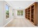 Bright home office with custom built-in shelving, recessed lighting, and serene pool views at 3010 Hammerwood Dr, Las Vegas, NV 89135