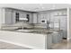 Open kitchen with stainless steel appliances, ample counter space, and plentiful gray custom cabinets at 3010 Hammerwood Dr, Las Vegas, NV 89135