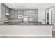 Kitchen with a large island and sink provides ample counter space and stylish gray cabinetry for storage at 3010 Hammerwood Dr, Las Vegas, NV 89135