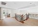 Upper level landing with decorative wrought iron railing and views to a sitting room at 3010 Hammerwood Dr, Las Vegas, NV 89135