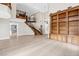 Grand living room with high ceilings, custom shelving, iron staircase, and gorgeous tile flooring at 3010 Hammerwood Dr, Las Vegas, NV 89135