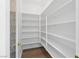 Walk-in pantry with white shelving units and laminate flooring offers ample space for storage at 3010 Hammerwood Dr, Las Vegas, NV 89135