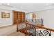 Elegant staircase with wrought iron details and a built-in bookshelf on the upper landing at 3010 Hammerwood Dr, Las Vegas, NV 89135