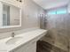 Modern bathroom featuring white vanity, quartz countertop, framed mirror, and glass enclosed walk-in shower at 3142 Espanol Dr, Las Vegas, NV 89121