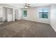 Spacious bedroom with large windows, ceiling fan, neutral carpet, and closet with built-in storage at 3142 Espanol Dr, Las Vegas, NV 89121