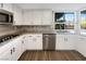 Modern kitchen featuring granite countertops, stainless steel appliances, and white cabinets at 3142 Espanol Dr, Las Vegas, NV 89121