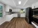Modern kitchen with white cabinetry, stainless steel appliances, and a window offering natural light and views at 3142 Espanol Dr, Las Vegas, NV 89121