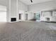 Open-concept living room with a fireplace, bar, and recessed lighting with access to other rooms at 3142 Espanol Dr, Las Vegas, NV 89121