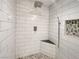 Modern walk-in shower with subway tile, stone floor, pebble accent, and a built-in shower bench at 3142 Espanol Dr, Las Vegas, NV 89121