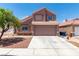 Charming two-story home features a well-maintained yard and a spacious two-car garage, inviting appeal at 3547 Empress Diamond Dr, North Las Vegas, NV 89032