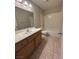 Bathroom featuring dual sinks, tiled floors, and shower-tub combination at 3729 Bronco Billy Ct, Las Vegas, NV 89129