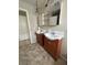 Bathroom with dual sinks, tiled floors, and modern lighting at 3729 Bronco Billy Ct, Las Vegas, NV 89129