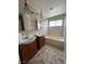Bathroom with dual sinks, tiled floors, and shower-tub combination at 3729 Bronco Billy Ct, Las Vegas, NV 89129
