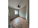 Bedroom featuring wood-look floors, a ceiling fan, and ample natural light at 3729 Bronco Billy Ct, Las Vegas, NV 89129