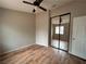Bright bedroom features hardwood floors, a ceiling fan, and mirrored closet doors at 3729 Bronco Billy Ct, Las Vegas, NV 89129