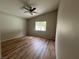 This bedroom features wood laminate floors, neutral walls, and a window for natural light at 3729 Bronco Billy Ct, Las Vegas, NV 89129