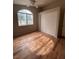 Bedroom with hardwood floors, big window, and closet at 3729 Bronco Billy Ct, Las Vegas, NV 89129