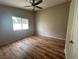 This bedroom includes laminate floors, neutral walls, and a window at 3729 Bronco Billy Ct, Las Vegas, NV 89129