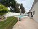 Fenced backyard features a kidney-shaped pool, small lawn, concrete patio, and mature trees at 3729 Bronco Billy Ct, Las Vegas, NV 89129