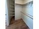 A walk-in closet with laminate floors, shelving, and a clothes rod at 3729 Bronco Billy Ct, Las Vegas, NV 89129