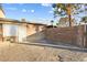 A private backyard area with stucco walls, a metal security gate, and hardscape at 3982 Voxna St, Las Vegas, NV 89119