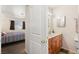 An open view into the bathroom with a single vanity, toilet, and mirror, located adjacent to the bedroom at 3982 Voxna St, Las Vegas, NV 89119
