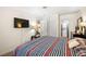 Bright bedroom featuring a television, carpeted floor and a closet at 3982 Voxna St, Las Vegas, NV 89119