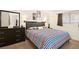 Comfortable bedroom with modern décor, natural lighting, and neutral carpeting at 3982 Voxna St, Las Vegas, NV 89119